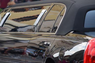 Side of black limousine, from rear door to tail light