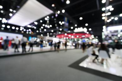 Trade show, out of focus shot with booths and people scattered around