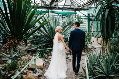 Wedding photography of couple walking in a green tropical venue