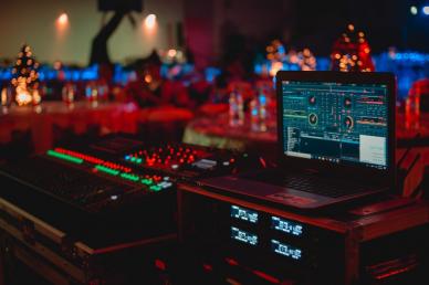 Sound board with red lighting reflecting on it