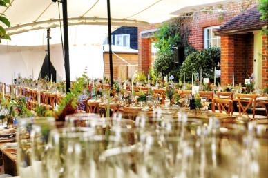 Wedding tables and chairs out of focus with decor on them