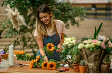 Woman making a bouquet of sunflowers in a flower shop