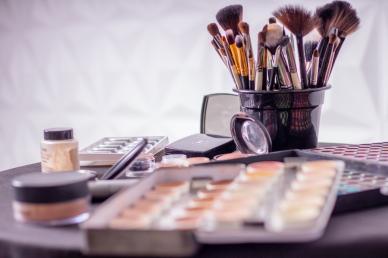 Makeup brushes and palettes in frame for a makeup artist