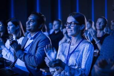 Audience clapping at a corporate conference