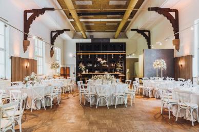 Wedding reception room filled with tables and chairs and wedding decor