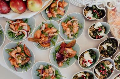 Catering display of individual bowls of food on a table