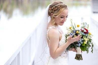 Bride holding bouquet of flowers in her wedding dress