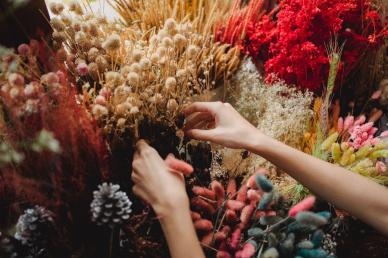 Woman's hands arranging a bouquet of flowers