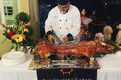 Man carving pig on on a table