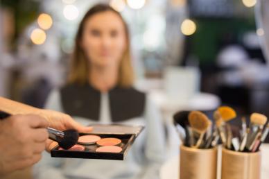 Makeup artist using makeup palette for a client