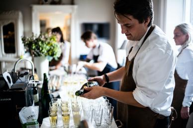 Serving staff pouring a glass of champagne