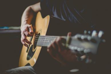 Man sitting and playing acoustic guitar