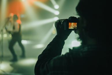 Videographer capturing live event performance