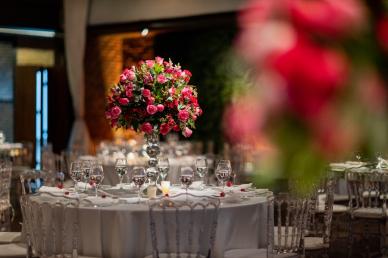 Floral arrangement as a centerpiece on a dining table at a wedding receptiont