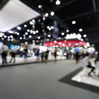 Trade show, out of focus shot with booths and people scattered around