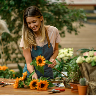 Woman making a bouquet of sunflowers in a flower shop