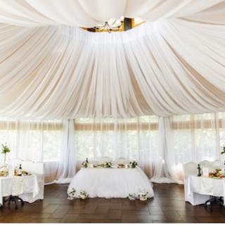 Event tent set up with linen draping and tables and chairs inside the tent