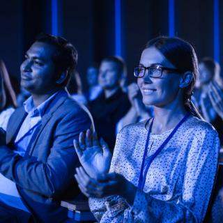 Audience clapping at a corporate conference