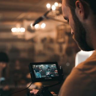 Videographer actively capturing content on his video camera