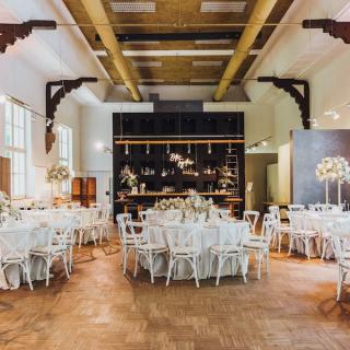 Wedding reception room filled with tables and chairs and wedding decor