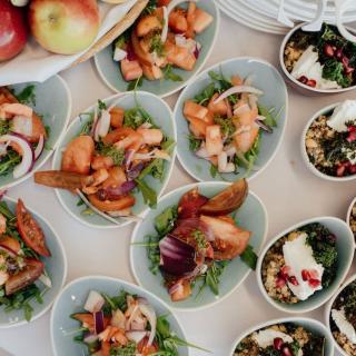 Catering display of individual bowls of food on a table