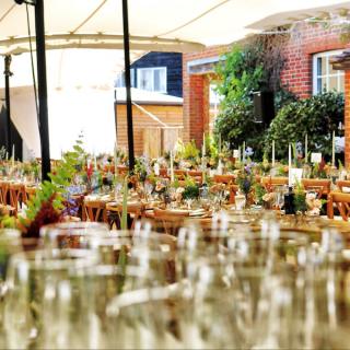 Tables and chairs organized for a wedding reception