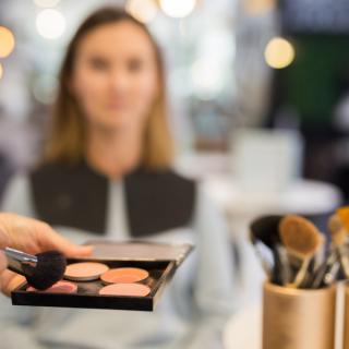 Makeup artist using makeup palette for a client