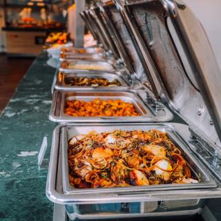 Buffet catering in metal pots lined up on a table