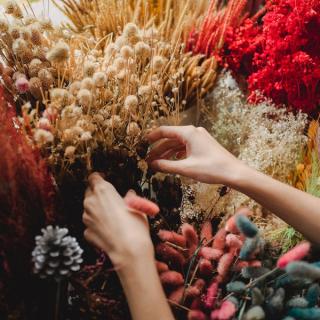 Woman tending to a bouquet of flowers