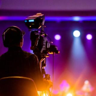 Videographer capturing live event performance