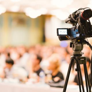 Video camera on a tripod, capturing a wedding ceremony