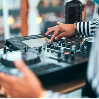 Dj full body cranking his equipment sound board